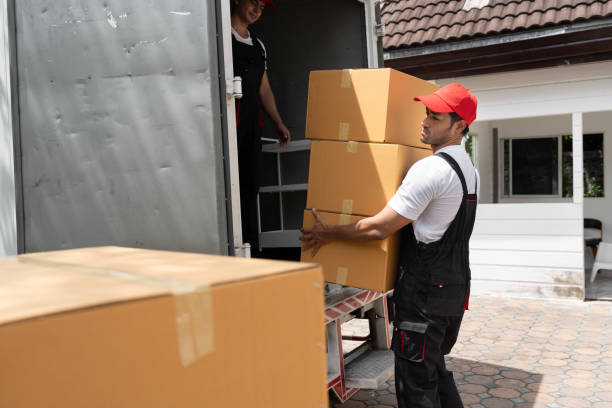 Professional movers carefully packing and moving household items